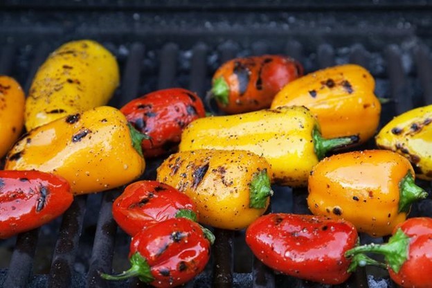 Colorful little roasted peppers on the grill